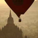 Red balloon flying over Bagan at sunset